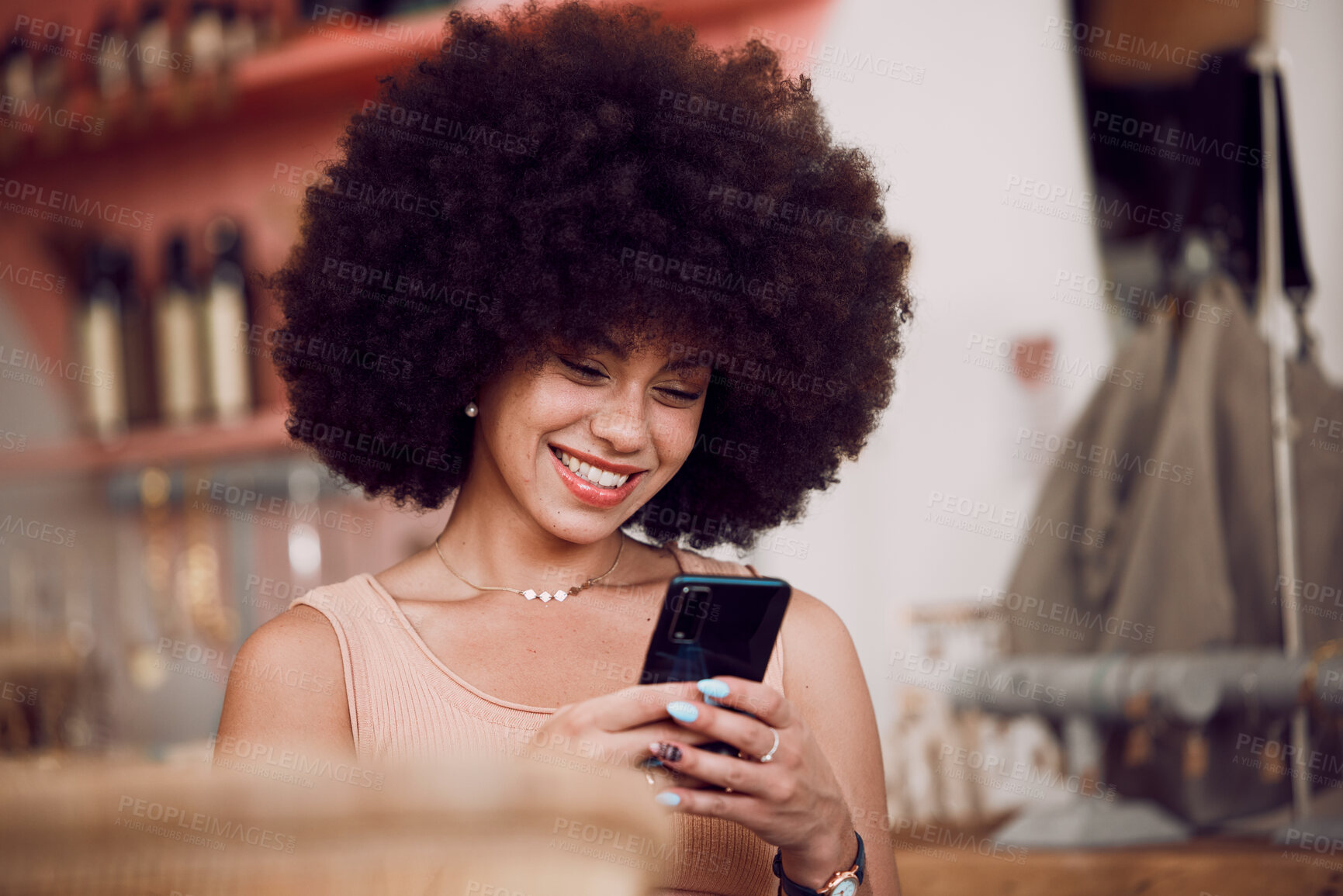 Buy stock photo Black woman, afro or phone in coffee shop, cafe or restaurant on social media app, internet esports game or fashion blog. Smile, happy or relax student, trendy blogger or tourist on mobile technology