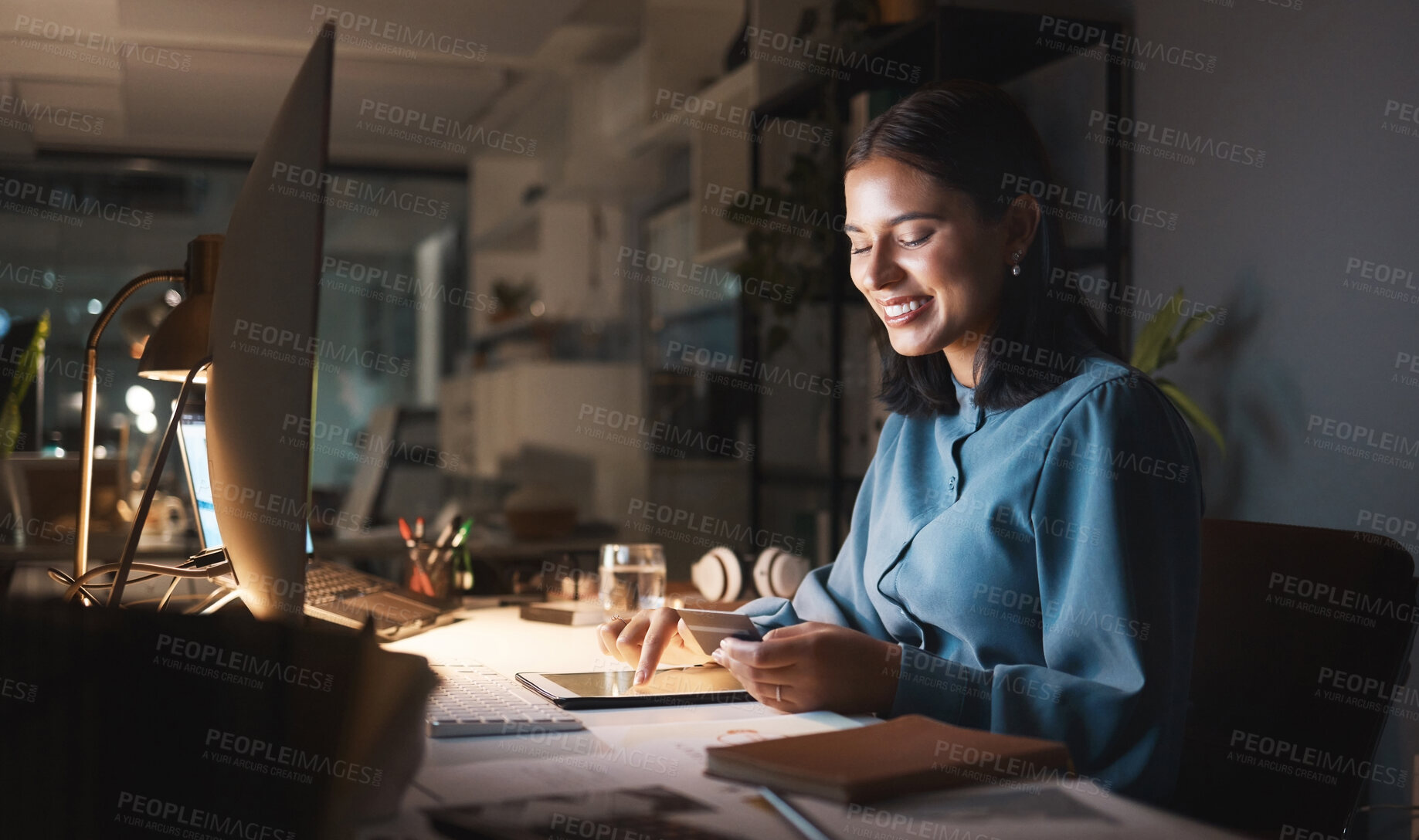 Buy stock photo Work, overtime and woman reading smartphone with tablet and computer working late on online design project. Night at office, happy designer networking for creative startup and checking social media.