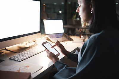Buy stock photo Phone, computer and night with a business woman typing a text message while working late in her office. Ecommerce, networking and communication with a female employee putting in overtime at work