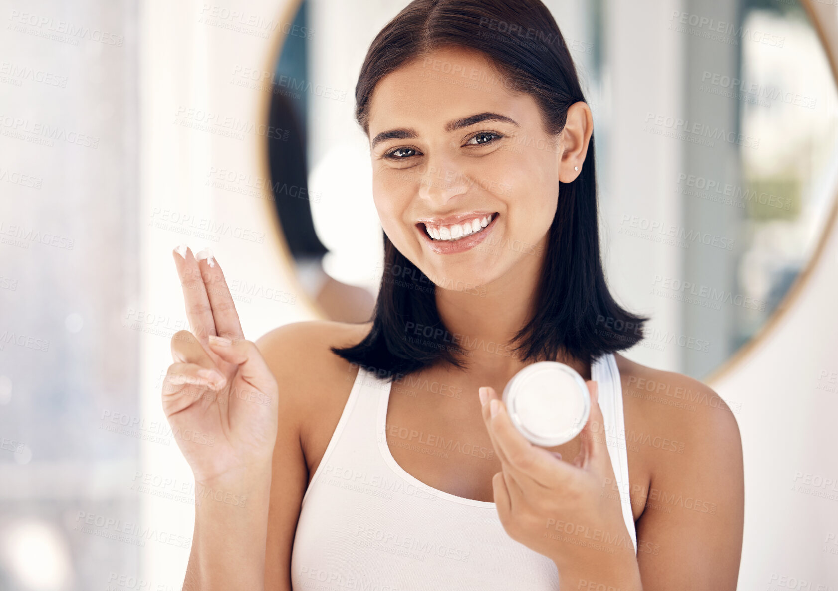Buy stock photo Face, beauty and skincare with a woman in the bathroom of her home to promote a cosmetic product. Portrait, antiaging and treatment with an attractive young female applying lotion to her skin