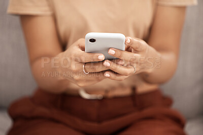 Buy stock photo Phone, hands and woman texting closeup on a sofa, social media or online chatting in a living room. Zoom, hand and girl internet search, browsing or checking news update, meme or post in her home 
