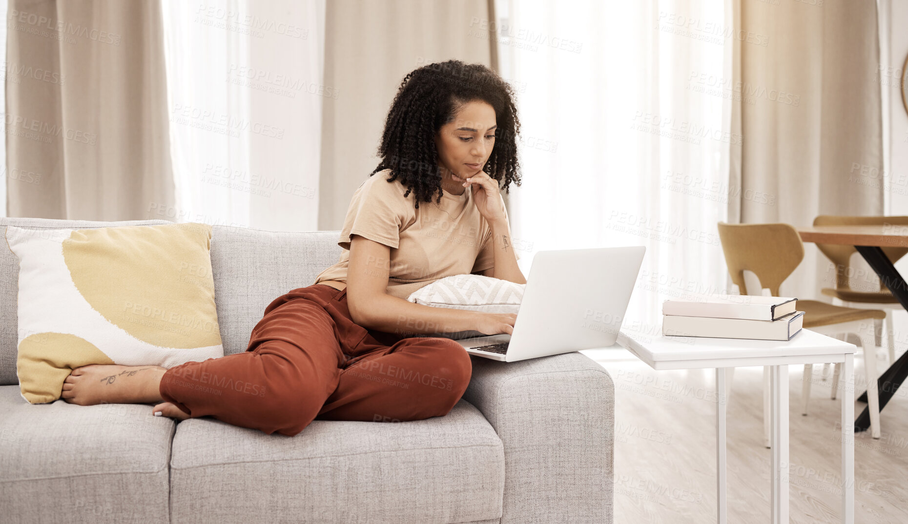 Buy stock photo Relax, laptop and woman on a sofa in a living room for news, social media or streaming in her home. Black woman, couch and online search for educational study, upskill and training tools in Africa