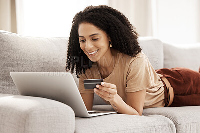 Buy stock photo Credit card, online shopping and laptop with a black woman customer browsing internet retail for a sale. Ecommerce, computer and store website with a female consumer buying from a sofa in her home