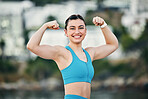 Fitness, portrait and woman flexing muscle, arms or biceps after strength training, workout or exercise for power. Smile, sports and happy strong girl bodybuilder athlete with growth development