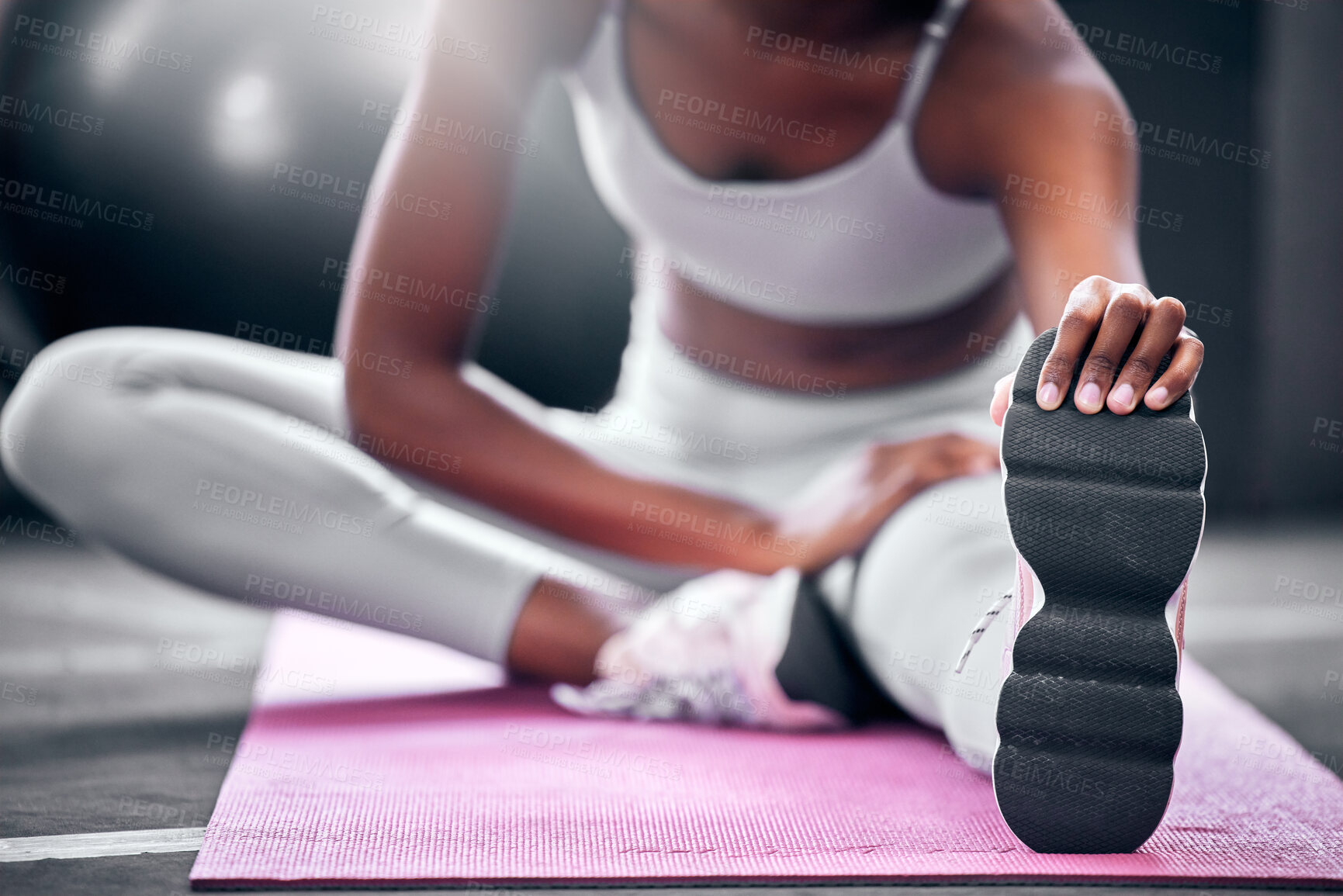 Buy stock photo Fitness, gym and black woman stretching legs on floor mat for wellness, health and body warm up. Healthy, exercise and athlete girl leg preparation for training, wellbeing and workout.

