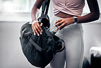 Woman, gym and water bottle in bag, hand and hydration at workout, training and fitness class. Black woman, exercise and gym bag for health, self care and wellness with drinking water in Los Angeles