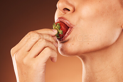 Buy stock photo Woman eating strawberry closeup on studio background, health and nutritional diet of fresh food. Wellness, nutrition and skincare, model in studio biting red fruit with makeup and cosmetics cropped.