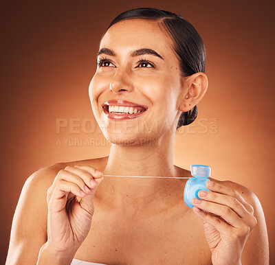 Buy stock photo Teeth, floss and woman in studio for dental, health and mouth care, fresh and happy on orange background mockup. Girl, model and flossing for gum, wellness and tooth protection, breath and hygiene