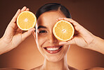 Skincare, woman and portrait with orange face for vitamin c, aesthetic and cosmetic treatment zoom. Health, wellness and self love model with smile for citrus dermatology campaign in brown studio.