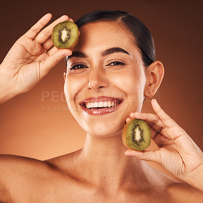 Buy stock photo Cosmetics, skincare and young woman with kiwi, natural beauty or healthy with brown studio background. Portrait, makeup or healthy girl with fruit, wellness or organic facial for smooth or clear skin