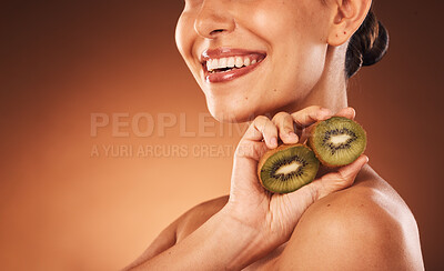 Buy stock photo Beauty, skincare and kiwi with a model woman in studio on a brown background for natural treatment or nutrition. Spa, nature and health with a young female holding fruit to promote wellness