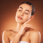 Face, beauty and skincare with a model woman in studio on a brown background for wellness or luxury. Spa, facial and cosmetics with an attractive young female posing to promote a skin product