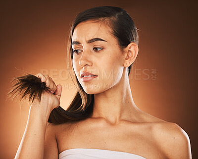 Buy stock photo Hair, keratin and treatment with a model woman in studio on a brown background for damage or split ends. Salon, haircare and shampoo with a frustrated female suffering or annoyed with her hairstyle