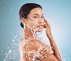 Water splash, beauty and black woman with peace from skincare, body wellness and spa self care against a blue background in studio. Liquid cosmetic, clean and portrait of a model with dermatology