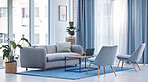 Empty living room interior, furniture and sofa in home with plants, chairs and carpet, rug and laptop and book on table. Room, modern design or interior design of luxury apartment, house or property.