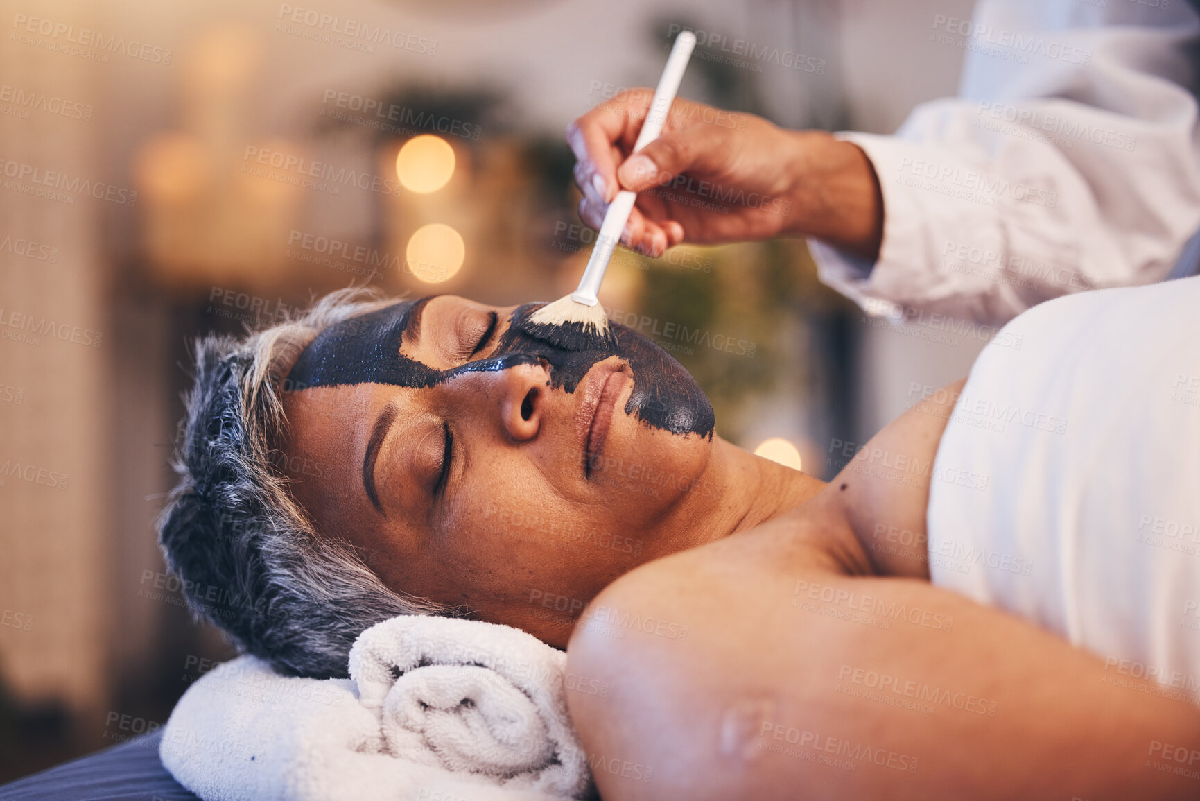 Buy stock photo Facial, relax and mask with a woman in spa, lying on a massage table or bed for skincare treatment. Peace, sleeping and wellness with a senior female customer in a health center for luxury care
