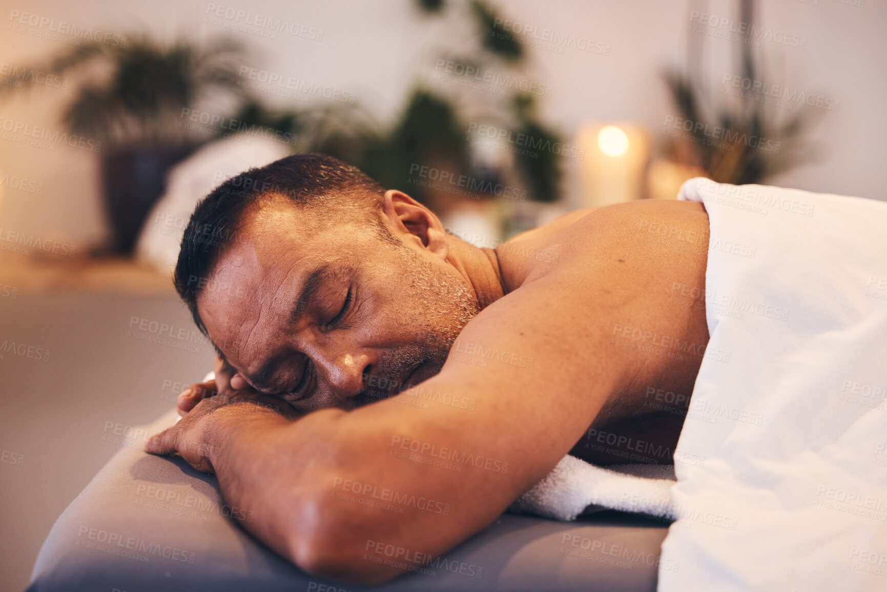 Buy stock photo Black man, spa and wellness to relax, healing massage and vacation at resort. Mature male, lying on table and enjoy physical therapy being zen, peace and calm for body care, rest and holiday.
