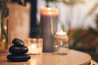 Buy stock photo Stone, candle and spa with a still life objects on a table in a wellness center for aromatherapy to relax. Background, rock and luxury with stones and candles in a health salon for stress relief