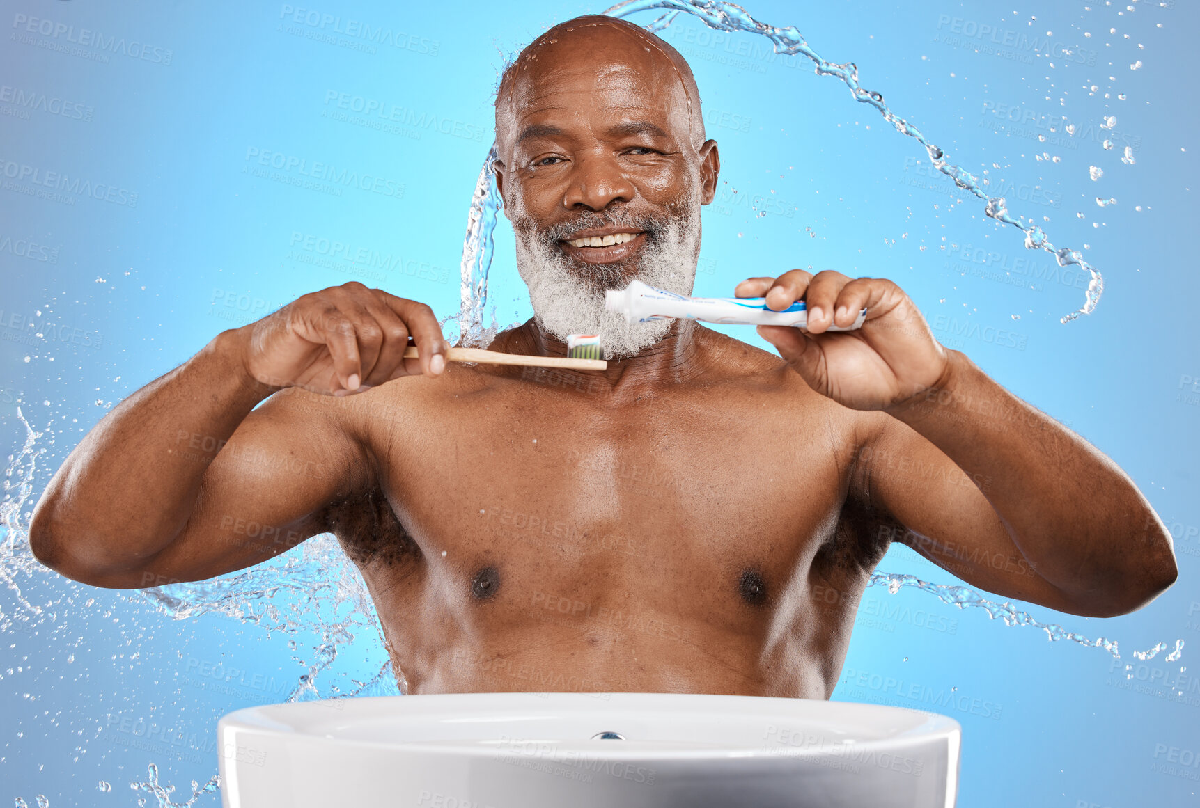 Buy stock photo Brushing teeth, bamboo and black man in studio with toothpaste for dental or mouth care product promotion on blue mockup. Senior black man portrait, eco friendly or wood toothbrush and water splash