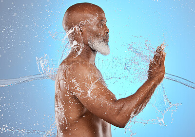 Buy stock photo Black man, skincare and water splash for beauty, cosmetics and dermatology on blue studio background for old age skin and body. Model cleaning, washing and shower for hygiene, health and wellness