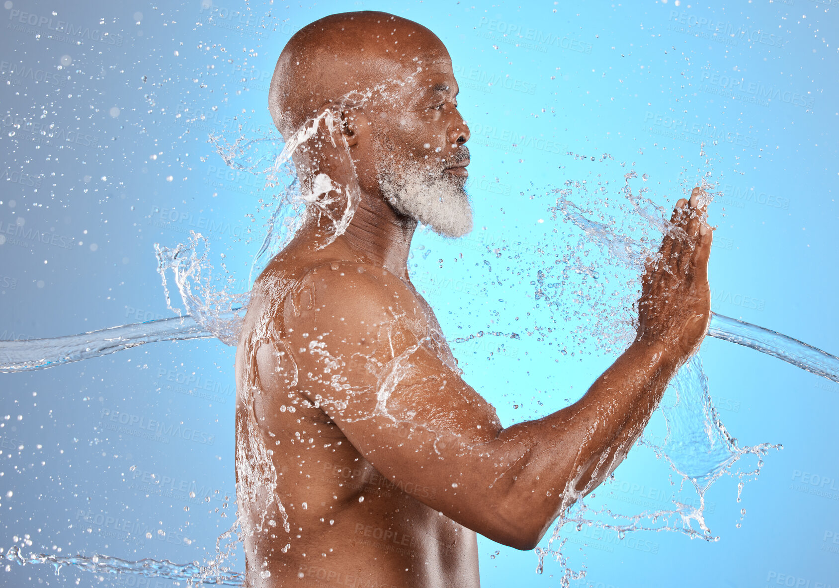 Buy stock photo Black man, skincare and water splash for beauty, cosmetics and dermatology on blue studio background for old age skin and body. Model cleaning, washing and shower for hygiene, health and wellness