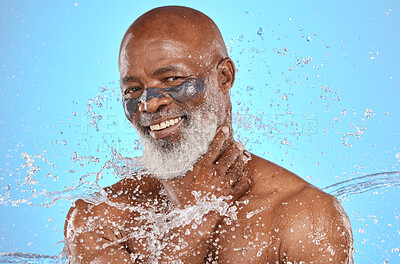 Buy stock photo Skincare, water and portrait of black man with facial on blue background in studio for wellness, spa and cleanse. Cleaning, beauty and senior male with water splash, facial mask and luxury treatment