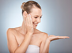 Beauty, skincare and woman in a studio with mockup space for a health, wellness and natural face routine. Cosmetic, healthy and happy girl model with a facial treatment by a gradient gray background.