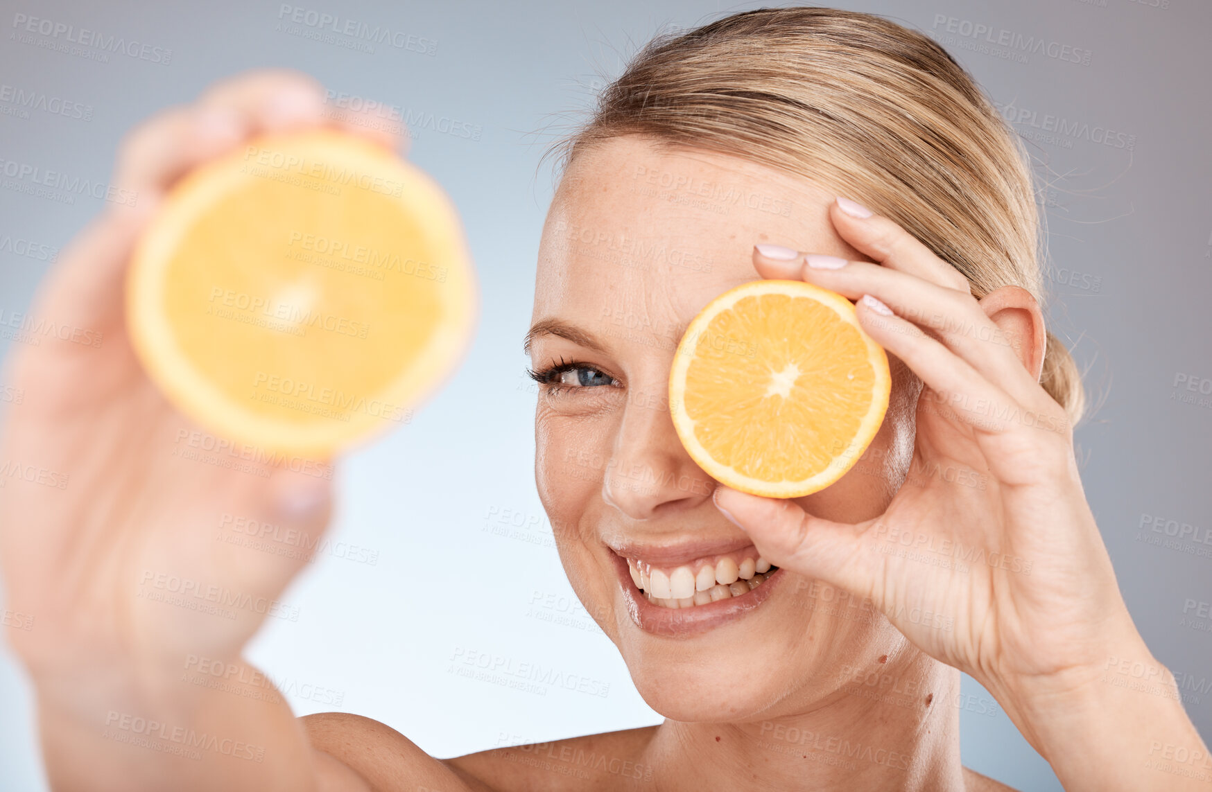 Buy stock photo Skincare, beauty and orange for woman as natural facial with citrus and vitamin c fruit for health and wellness on studio background. Portrait, face and smile of Canada model for organic dermatology