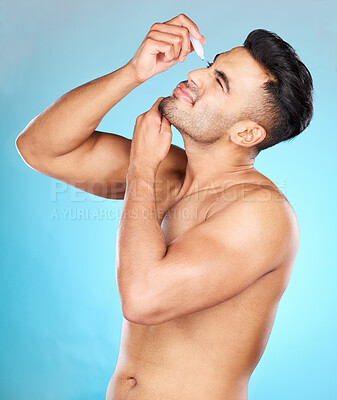 Buy stock photo Health, vision and man with eye drops for allergy on blue background for wellness, eye and optical care. Optometry, healthcare and young male apply liquid, drops and medicine in eyes for contact lens