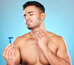 Skincare, shaving and man with razor in studio on blue background for wellness, beauty and self care. Grooming, facial treatment and male face with worry, concern and anxiety to shave sensitive skin