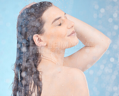 Buy stock photo Water, shower and woman cleaning body on blue background of healthy skincare, beauty or wellness. Young studio model, water drops and personal hygiene, bathroom and cosmetics, self care or fresh face