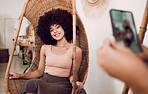 Black woman, smile and swing chair with a phone for a photograph for social media, blog or online marketing or advertising. Smile of influencer happy while posing for profile picture as network user