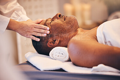 Buy stock photo Hands, head and massage with a man in a spa on a bed or table for wellness, luxury or stress relief treatment. Relax, zen and beauty with a male customer lying in a health center for physical therapy