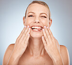 Face, skincare and beauty with a model woman in studio on a gray background for natural treatment. Portrait, facial and wellness with an attractive young female posing to promote luxury care