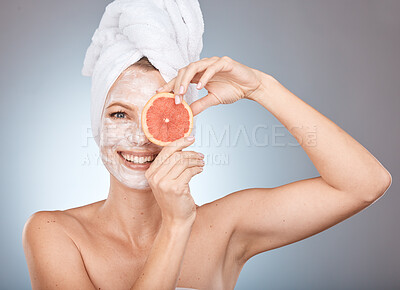 Buy stock photo Portrait, beauty and facial with a woman in studio on a gray background holding an orange slice for natural care. Face, skincare and cosmetics with a female posing to promote a wellness product