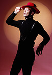 Fashion, aesthetic and black man with vitiligo in studio isolated on a red background. Beauty, creative pose and stylish male model posing in designer hat, trendy and luxury clothing on a backdrop.