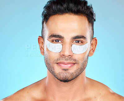 Buy stock photo Beauty, eye patch and face with man and eye care, cosmetic treatment portrait with healthy skin against blue studio background.  Dermatology, cosmetics mockup and skin care with grooming and facial.