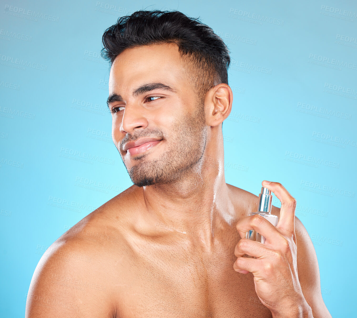 Buy stock photo Man, smile and perfume for aroma, fragrance and natural beauty against blue studio background. Young male, confident gentleman and cologne for manly scent, wellness and to smell good for hygiene.