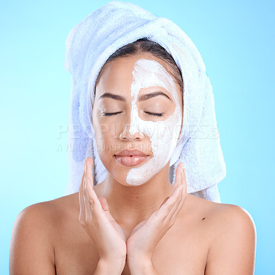 Buy stock photo Beauty, face mask and skincare of a woman on blue studio background for dermatology, cosmetics and facial product. Aesthetic model with hands under face for spa, zen and luxury skin treatment