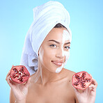 Beauty cream, face and woman with pomegranate, skincare and vitamin c for health, wellness and towel after shower in blue studio background. Model portrait, fruit and skin care, detox or clean facial