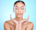 Skincare, hands and face of woman in studio for natural healing, youth glow and skin wellness on blue mockup for marketing. A young beauty model, facial cosmetics and makeup promotion for dermatology