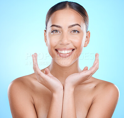 Buy stock photo Portrait, skincare and woman with hands on face in studio for beauty, wellness and grooming on blue background. Facial, hand and girl relax after skin, treatment and cosmetics with wellness product