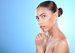 Portrait, beauty and mockup with a model black woman in studio on a blue background for skincare. Face, cosmetics and space with an attractive young female posing to promote a product on advertising