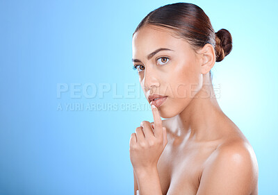 Buy stock photo Portrait, beauty and mockup with a model black woman in studio on a blue background for skincare. Face, cosmetics and space with an attractive young female posing to promote a product on advertising