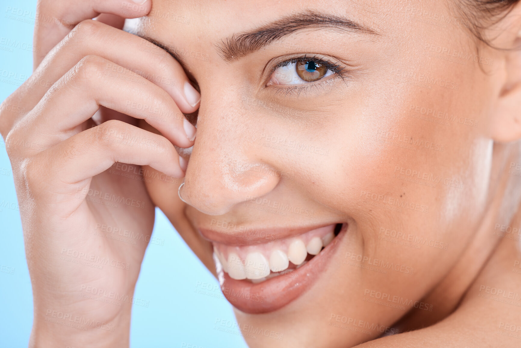 Buy stock photo Skincare, makeup and smile of a woman for beauty, cosmetics and dermatology against a blue background in studio. Spa face, eyes and portrait of a cosmetic model happy with facial cosmetology