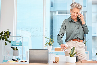 Buy stock photo Phone call, woman and plant in modern office, eco friendly business or sustainable. Senior female, mature lady and smartphone for communication, water to spray leaves or talking in workplace or smile