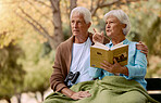 Birdwatching, book and binoculars with a senior couple sitting on a park bench together in nature. Forest, love and retirement with a mature man and woman in a garden to relax with a summer view
