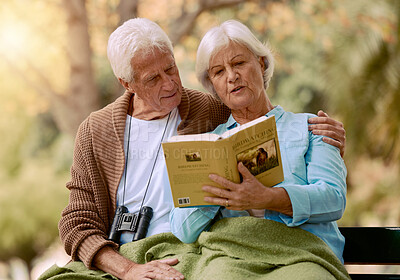 Buy stock photo Park, senior and couple reading a book, relaxing and bonding outdoors with blanket. Love, retirement and elderly man and woman studying literature, story or novel and enjoying quality time together.
