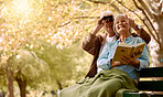 Retirement, relax and couple on bench at park in New York, USA for marriage leisure on pension. Love, care and happy elderly people bonding in nature together with blanket and cheerful smile.