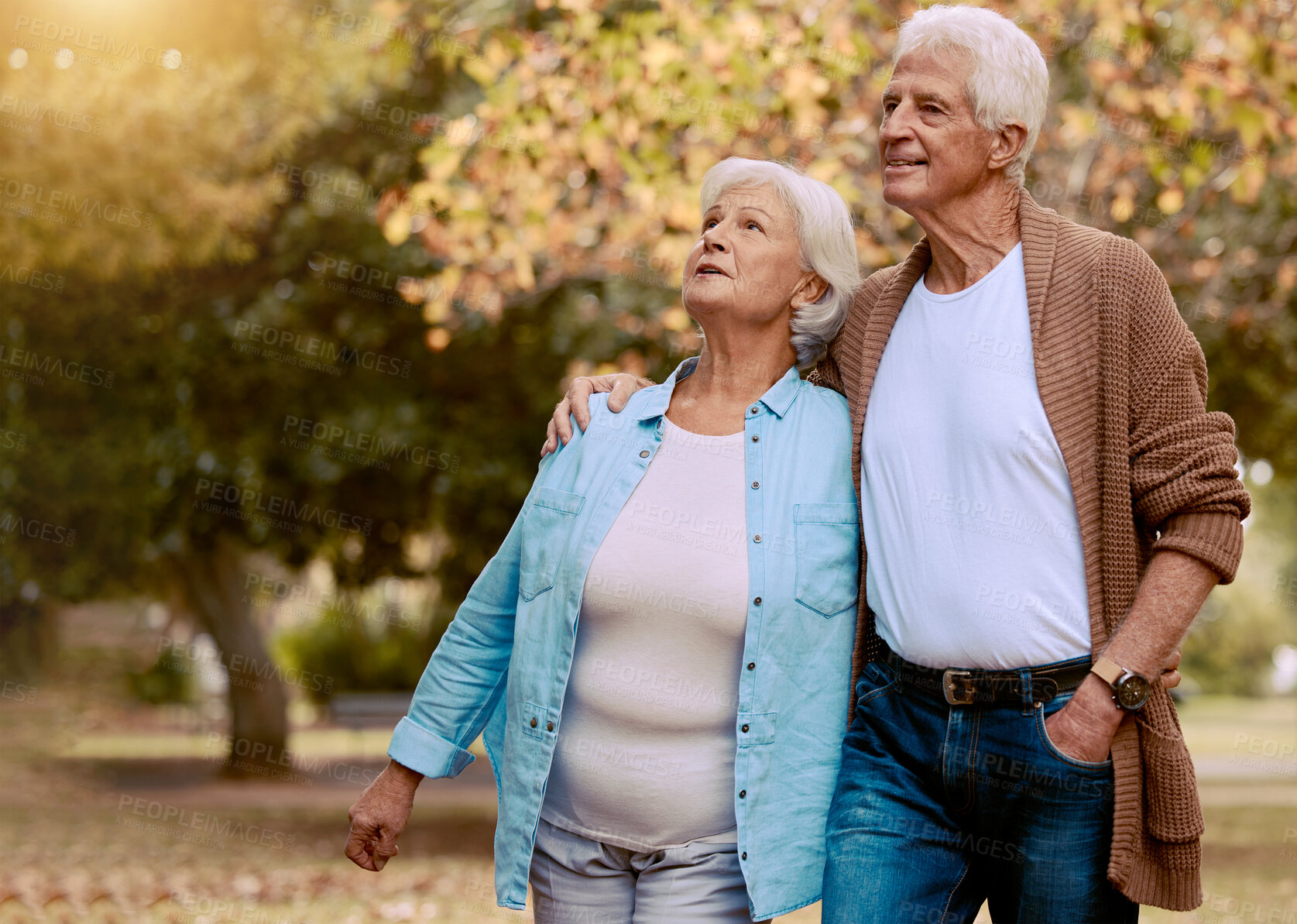 Buy stock photo Senior couple walking in park for retirement, love and care together to enjoy quality time, marriage and relationship. Old man, woman and elderly people in autumn garden, nature and relax outdoors 